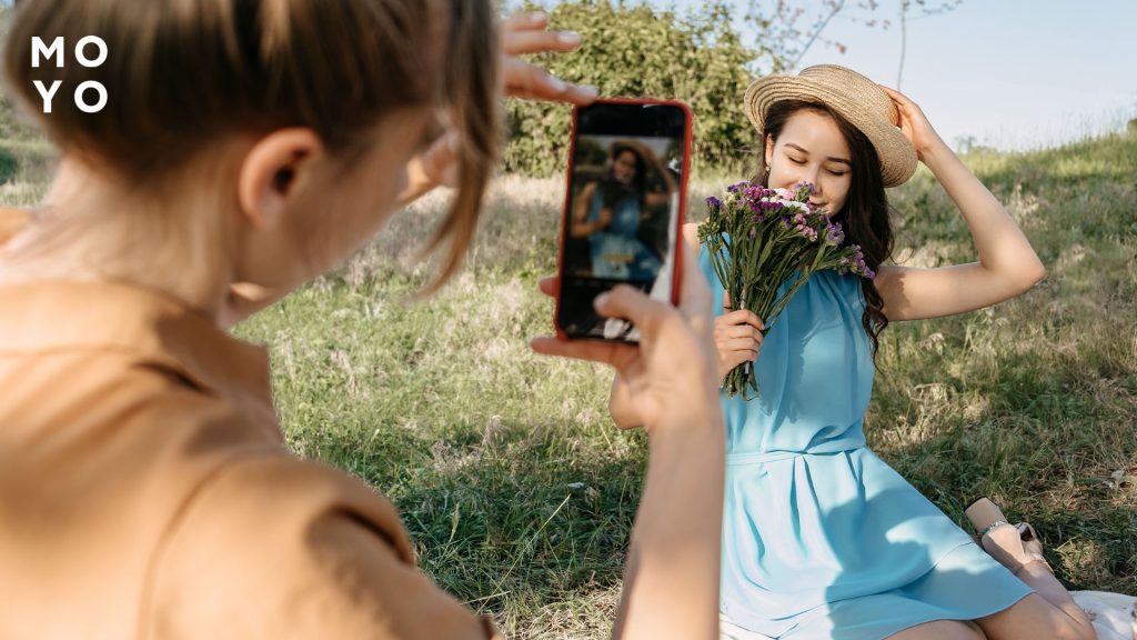 дівчина фотографує подругу